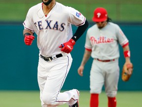 Texas Rangers' Nomar Mazara rounds the bases past Philadelphia Phillies' Freddy Galvis after hitting a solo home run on May 16, 2017, in Arlington, Texas. (TONY GUTIERREZ/AP files)