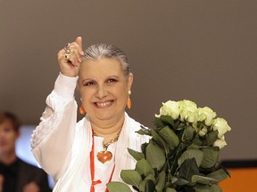 In this June 24, 2007 file photo, Italian Fashion designer Laura Biagiotti acknowledges the applause at the end of her Laura Biagiotti Spring/Summer 2008 men's collection, presented in downtown Milan, Italy. An Italian hospital official said on Thursday, May 25, 2017 that designer Laura Biagiotti suffered a heart attack that caused brain damage. (AP Photo/Luca Bruno, files)