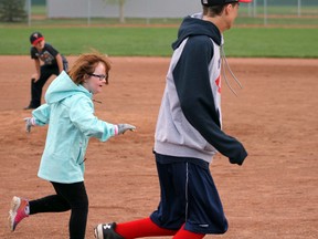 Photo by Jesse Cole Reporter/Examiner
Avery Murphy plays a game of challenger baseball alongside her Bantam AAA buddy Ryan Olson. Murphy is one of 33 kids who have signed up for the challenger baseball program this year.