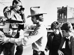 In this Feb. 16, 1984, file photo, Genene Jones, second right, is escorted into Williamson County Courthouse in Georgetown, Texas. Jones, a former nurse who's been serving a 99-year prison sentence since 1984 for the fatal overdose of an infant in her care, is due for early release in March 2018. A grand jury indicted her on Thursday, May 25, 2017, in the death of another infant as prosecutors try to keep her behind bars. (AP Photo/Ted Powers, File)