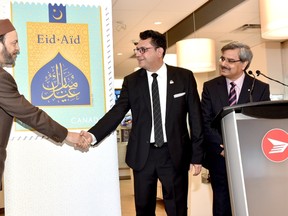 Canada Post unveils a special stamp commemorating the Muslim Eid festivals alongside community members on May 23, 2017 (Twitter/Canada Post)