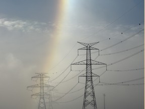 One side of a sun dog appears over power line towers as temperatures hovered around -18 C in Edmonton, Tuesday, January 3, 2017.