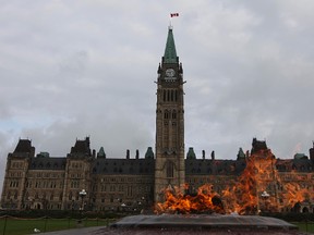 Parliament Hill is seen behind the Eternal Flame in this Sept 22, 2010 file photo in Ottawa. (Postmedia Network files)
