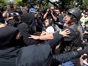 In this April 15, 2017 file photo, anti-Donald Trump protesters clash with supporters during competing demonstrations at Martin Luther King Jr. Civic Center Park in Berkeley, Calif. (Anda Chu /San Jose Mercury News via AP, File)