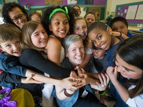 Julie Duncan, a teacher at Manor Park Public School, is mobbed by her students during FamJam.
