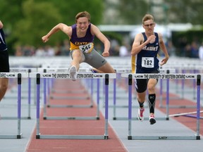 Liam Mather of Central wins the senior boys 110m hurdles in a time of 14.04 ahead of CCH's Matthew MacGillivray with a time of 14.25 during the first day of OFSAA West regional track and field meet Friday in London. (MIKE HENSEN, The London Free Press)