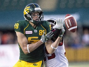 Calgary Stampeders Jamar Wall (29) blocks the football on Edmonton Eskimos Chris Getzlaf (89) during second half CFL action in Edmonton, Alta., on Saturday September 10, 2016. Free agent slotback Getzlaf re-signed with the Edmonton Eskimos on Friday.