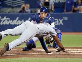 Elvis Andrus of the Texas Rangers is tagged out at home plate by Russell Martin of the Toronto Blue Jays at Rogers Centre on May 26, 2017 in Toronto. (Tom Szczerbowski/Getty Images)