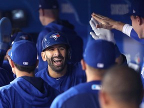 Jose Bautista of the Blue Jays is congratulated by teammates in the dugout after hitting a three-run home run against the Texas Rangers at Rogers Centre on May 27, 2017 in Toronto. (Tom Szczerbowski/Getty Images)