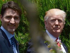 Prime Minister Justin Trudeau and U.S. President Donald Trump walk together during the G7 Summit in Taormina, Italy on Saturday, May 27, 2017. THE CANADIAN PRESS/Sean Kilpatrick