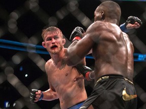 Alexander Gustafsson (left) throws a punch at Jon Jones during their bout at UFC 165 in Toronto on Saturday September 21, 2013. (THE CANADIAN PRESS/Chris Young)
