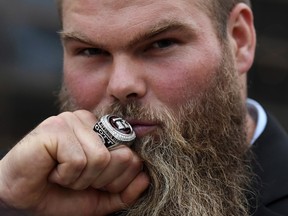 Redblacks offensive linesman John Gott poses with his Grey Cup ring after being presented with it on Friday. (The Canadian Press)