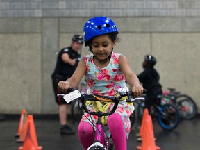 Hyab Gidey ,6, takes part in the eighth Annual Bike Festival at the Edmonton Expo Centre Saturday. on Saturday May 27, 2017, in Edmonton.  100 kids involved with the Boys and Girls Clubs Edmonton meet with volunteers from the Edmonton Police, AMA, Northlands, Brain Care Centre, Sport Central, Alberta Health Services, Edmonton Dinner Optimist Club and the Alberta Office of Traffic Safety to learn bike safety skills. Kids take home a free bike helmet, bike lock, and bell. Kids who don’t have a bike will get a donated bike later from Sport Central. Greg  Southam / Postmedia