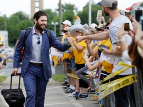 Nashville Predators’ Mike Fisher is greeted by fans as players arrive at the airport to leave for Pittsburgh on Saturday. (The Associated Press)