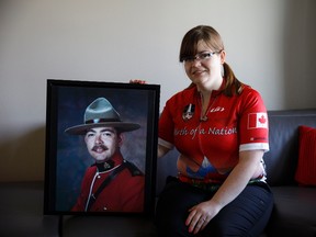 Kim McKerry poses with a photo of her late father, Philip McKerry, at her home in Edmonton on Saturday, May 27, 2017. McKerry is riding in the Cycle to Vimy event to honour the fallen and help those with PTSD, which her father suffered from. (Codie McLachlan/Postmedia)