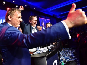 Andrew Scheer, centre, is congratulated by Maxime Bernier after being elected the new leader of the federal Conservative party at the federal Conservative leadership convention in Toronto on Saturday, May 27, 2017. THE CANADIAN PRESS/Frank Gunn