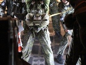 A paratrooper from the 3rd Battalion, Princess Patricia's Canadian Light Infantry signals as 26 Canadian paratroopers prepare to jump from a New Zealand Royal Air Force’s C-130 Hercules over Meadow Lake, Sask., on May 25. The jump was part of the Maple Flag exercises held out of CFB Cold Lake, Alta.