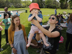 Mom, Carolyn Johanson, right, Lia, 6 months, and midwife Marissa Charbonneau, left, take part in a midwife picnic at McKellar Park in Ottawa on Sunday, May 28, 2017.   (Patrick Doyle)