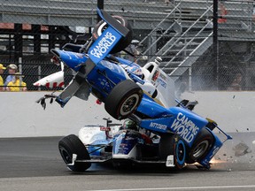 The car driven by Scott Dixon goes over the top of Jay Howard in the first turn during the Indianapolis 500 at Indianapolis Motor Speedway, Sunday, May 28, 2017, in Indianapolis. (AP Photo/Marty Seppala)