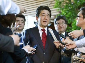 Japanese Prime Minister Shinzo Abe, center, answers to a reporter's question about North Korea's missile launch, at his official residence in Tokyo Monday morning, May 29, 2017. North Korea on Monday fired an apparent ballistic missile off its east coast that landed in the waters of Japan's economic zone, South Korean and Japanese officials said, the latest in a string of recent test launches as the North seeks to build nuclear-tipped ICBMs that can reach the U.S. mainland. (Muneyuki Tomari/Kyodo News via AP)