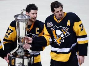 Pittsburgh Penguins’ Sidney Crosby (87) and Evgeni Malkin (71) pose with the the Prince of Wales Trophy in Pittsburgh, Thursday, May 25, 2017. (AP Photo/Gene J. Puskar)