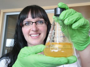 Nadia Mykytczuk, an environmental microbiologist at the Living with Lakes Centre, displays a water sample. (Gino Donato/Sudbury Star)