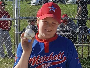 Lucas Roobroeck holds the ball he hit out of the park in Holmesville, highlighting the Mitchell Mosquito's OBA team's tournament championship in Clinton this past weekend. SUBMITTED