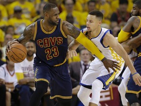 Cleveland Cavaliers forward LeBron James (23) dribbles against Golden State Warriors guard Stephen Curry during the first half of Game 1 of basketball's NBA Finals in Oakland, Calif June 2, 2016. (AP Photo/Marcio Jose Sanchez)