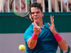Canada's Milos Raonic returns the ball to Belgium's Steve Darcis during their tennis match at the Roland Garros 2017 French Open on May 29, 2017 in Paris. / AFP PHOTO / François-Xavier MARIT