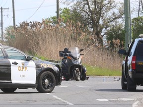 A collision between a three wheeled motorcycle and a transport truck Monday afternoon on Dorchester Road just north of the 401 left the passenger on the motorcycle dead, and the driver critically injured.Photograph taken on Monday May 29, 2017. The transport was crossing Dorchester Road from the westbound exit to the westbound entrance ramps when the collision with the southbound trike occured according to police. Mike Hensen/The London Free Press/Postmedia Network