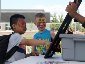 Kindergarten students Kyle Cunanan (left) and Kaden Bond play games for prizes while they visit the Grande Prairie Children's Festival with fellow St. Catherine School students on the grounds south of the Grande Prairie Public Library on Friday May 26 in Grande Prairie.
Kevin Hampson/Daily Herald-Tribune