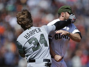 Washington Nationals' Bryce Harper punches San Francisco Giants' Hunter Strickland in the face after being hit with a pitch in the eighth inning of a baseball game Monday, May 29, 2017. (AP Photo/Ben Margot)