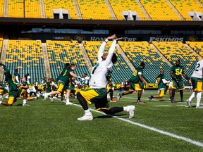 Players stretch during Edmonton Eskimos training camp at Commonwealth Stadium in Edmonton on May 29, 2017.