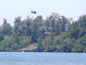 An Ontario Provincial Police helicopter is flown over Lake Erie in Kingsville, Ontario as the search continuesd Monday for the young male involved in a capsized canoe, Sunday.