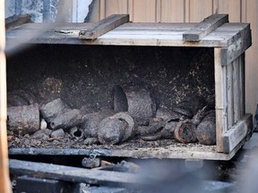 A box with the leftovers of grenades is pictured in front of a garage in Hennef, western Germany, Tuesday, May 30, 2017. Police in western Germany say a neighborhood was evacuated Monday afternoon after World War II-era grenades and other munitions bought at a flea market began exploding in summer-like heat. (Henning Kaiser/dpa via AP)