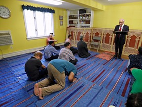 In this Friday, Sept. 23, 2016 file photo, Iftakhar Ahmad, top, a visiting religious leader from Pakistan, leads a prayer service at the Bernards Township Community Center in Basking Ridge, N.J. The Bernards Township committee voted Tuesday, May 23, 2017, to settle two lawsuits over its denial of a proposed mosque, filed by the U.S. Justice Department and the Islamic Society of Basking Ridge. Some residents say their opposition is because of the selected location, not religious intolerance. (AP Photo/Julio Cortez, File)