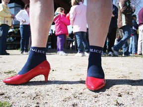 Woodstock Police Const. Steven McEwen sported some special socks with his red, high heel pumps in the Walk a Mile in Her Shoes fundraiser for Domestic Assault Services Oxford in Southside Park. (File photo)