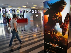 A man walks past a poster promoting the movie, Wonder Woman, at a cinema in downtown Beirut, Lebanon, Tuesday, May 30, 2017. Lebanon's ministry of economy says it has asked the country's security agency to ban the movie because its lead actress, Gal Gadot, is an Israeli. (AP Photo/Hussein Malla)