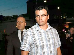 Ken Pagan, accompanied by his lawyer Tyler Smith, Toronto Police arrives at 52 Division on Thursday October 6, 2016. (Stan Behal/Postmedia)