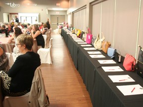 A row of handbags in the silent auction at the event. (Justine Alkema/Clinton News Record)