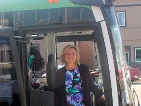 Whitecourt Mayor Maryann Chichak stands at the entrance of one of the town's brand new buses on May 29 (Jeremy Appel | Whitecourt Star).