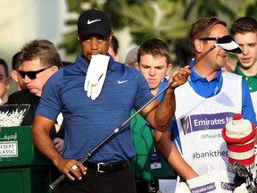 This file photo taken on February 1, 2017 shows Tiger Woods of the United States reacting after playing a shot during the Dubai Desert Classic golf tournament at the Emirates Golf Club in Dubai. (AFP PHOTO)