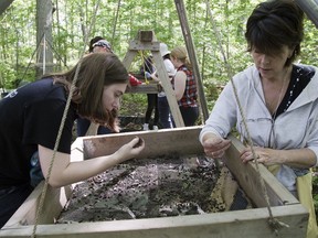 Allison Taylor, left, and Michele Paterson sift for 500-year-old artifacts during the Excavation Open House at London?s Museum of Ontario Archaeology. (DEREK RUTTAN, The London Free Press)