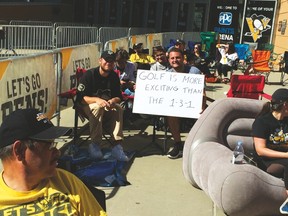 A fan holds up a sign outside PPG Paints Arena before a Senators-Penguins playoff game (Don Brennan)