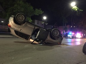 An SUV flipped on its roof on Corydon Avenue late Tuesday night. (David Larkins/Winnipeg Sun)