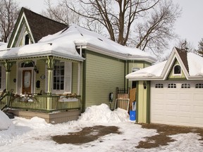 A standout even in the snow, this Ontario Cottage on London?s Byron Avenue received a 2015 Heritage Award for its restoration, complete with a matching garage. (Free Press file photo)