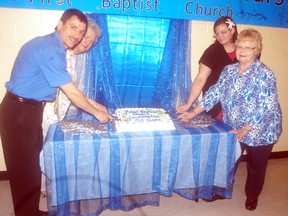 Members of Wallaceburg's First Baptist Church cut a cake to celebrate a year-long 150th anniversary celebration on Sunday. Cutting the cake from left to right, Brian Horrobin, Barbara Myers, Jodie Shaw and Denise Shephard.