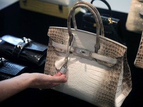 This file photo taken on May 4, 2016 shows a Matte White Himalaya Niloticus Crocodile Diamond Birkin with 18K gold and diamond hardware on display during a preview at Christies in Hong Kong on May 4, 2016, identical to another Hermes bag that sold for 379,261 USD (2.94 million HKD) after intense bidding on May 31, 2017, a spokeswoman for auction house Christie's told AFP.
A diamond-encrusted crocodile-skin Hermes handbag with white gold details has broken the record for the world's most expensive ever sold at auction, fetching nearly 380,000 USD at a Hong Kong sale on May 31, 2017. / AFP PHOTO / ISAAC LAWRENCEISAAC LAWRENCE/AFP/Getty Images