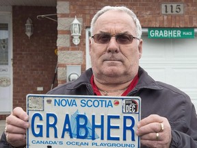 Lorne Grabher displays his personalized licence plate in Dartmouth, N.S. on Friday, March 24, 2017. Lawyers for a Nova Scotia man fighting to have his last name reinstated on a controversial licence plate are due in court today to argue his Charter rights have been violated. (THE CANADIAN PRESS/Andrew Vaughan)