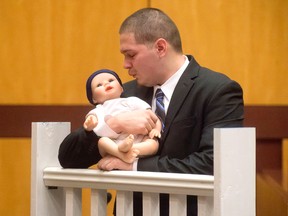 Tony Moreno demonstrates to the jury how he held his son Aaden on the railing of the Arrigoni Bridge in the final moments of Aaden’s life, during Moreno’s trial Thursday, Feb. 16, 2017, in Middletown, Ct. (Patrick Raycraft/Hartford Courant via AP, Pool)